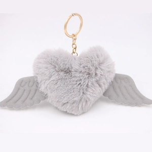 Detail of grey plush heart keychain with soft wings and a golden metal ring