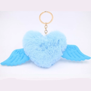 Detail of light blue plush heart keychain with wings and gold metal ring attachment