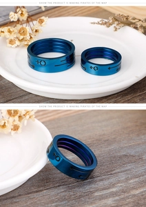 Close-up of blue stainless steel couple rings with male and female gender symbols