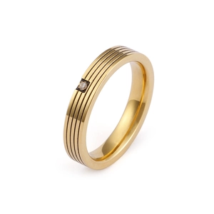 Minimalist gold titanium steel ring with triple grooves and a single sparkling zircon