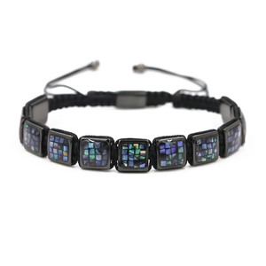 Detail of adjustable woven bracelet featuring square metal frames with shell inlay