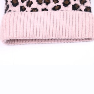 Detailed macro view of pink leopard print knit hat showing thick ribbed edge texture