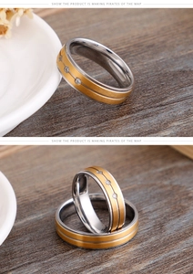 Detail of two-tone matte titanium steel rings with three small zircon stone inlays