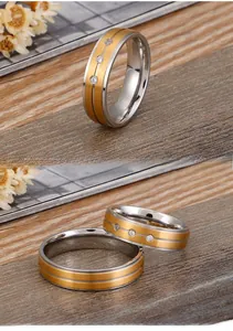 Macro detail of brushed gold and silver titanium rings with embedded cubic zirconia