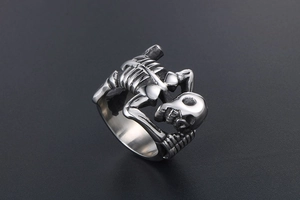 Close-up of a silver skull ring in punk style with detailed stainless steel texture