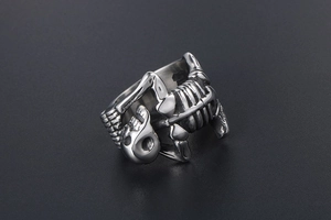 Detailed close-up of a titanium steel skull ring with vintage bone structure design