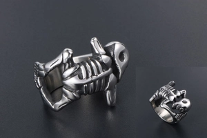 Macro side view of silver titanium steel skull ring showing detailed skeletal bone structure