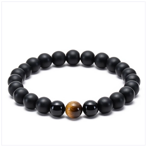 Close-up of natural yellow tiger eye and matte lava stone beaded bracelet for couples