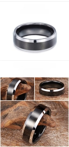 Polished silver and black tungsten steel ring shown on wooden and linen display background