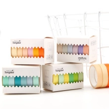 Close-up of assorted plaid washi tape sets in colorful boxes for DIY scrapbooking