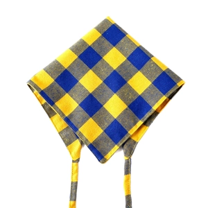 Detail of yellow and blue plaid cotton pet bandana showing woven fabric texture and ties