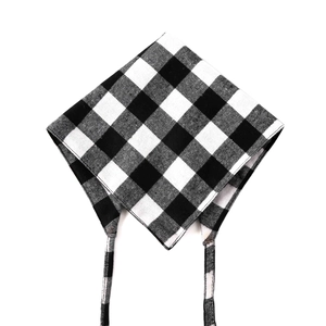 Detailed view of black and white plaid cotton dog bandana with durable tie straps