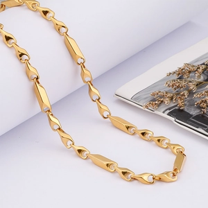 Polished gold stainless steel necklace with geometric diamond-shaped links on white background