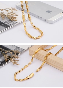 Close-up of golden geometric link chain with secure lobster clasp and stylish textured detail
