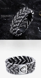 Detailed close-up of men's punk skull bracelet with V-shaped links and gothic engraving