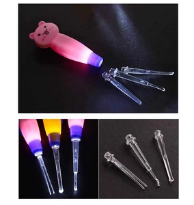 Detail view of pink bear earwax removal tool with LED light and clear plastic tips