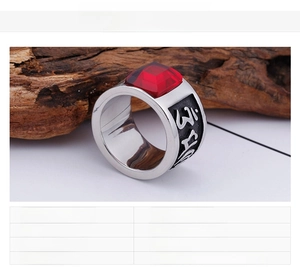 Close-up of titanium steel ring featuring a large red gemstone and vintage carvings