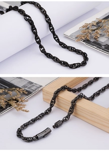 Close-up of black matte chain necklace for men with sturdy cylindrical clasp on white background
