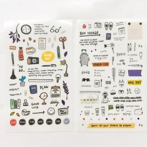 Detail of multi-color watercolor stickers with travel journal icons and inspirational phrases