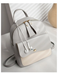 Close-up of contrast grey and beige women's backpack featuring metal zippers and flap pocket