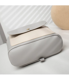 Detailed view of the contrast color bag bottom with gray faux leather and side strap ring