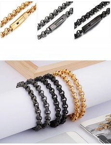 Macro detail of industrial vintage embossed metal chains in gold, black, and silver finishes