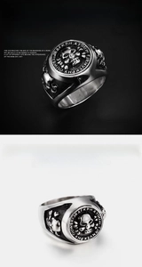 Detailed views of a vintage silver skull ring with gothic engravings and polished finish