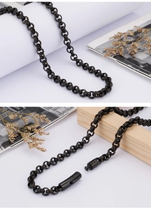 Detail of a black patterned metal chain with a unique lobster clasp on a clean background
