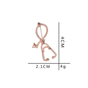 Rose gold stethoscope brooch pin for medical staff measures 4cm by 2.1cm and weighs 4g