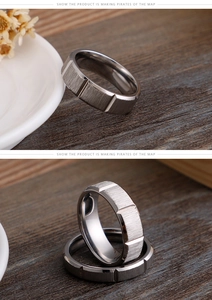 Close-up of gunmetal grey brushed stainless steel ring on rustic wood background