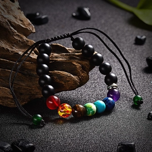 Detailed macro shot of 7 chakra natural stone beads on black braided adjustable rope