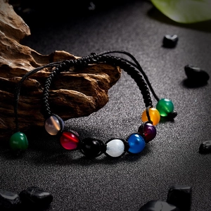 Close-up of 8mm seven chakra natural stone beads on a handmade woven braided bracelet
