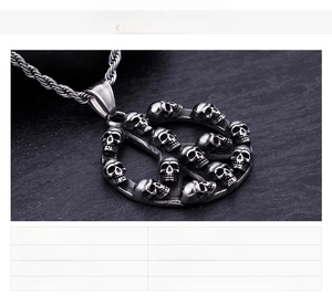 Detailed close-up of stainless steel peace sign and skull pendant with a twist chain