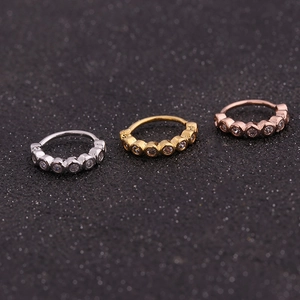 Three dainty zircon-studded nose studs in silver, gold, and rose gold finish colors