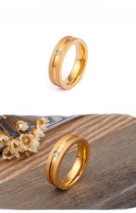 Detailed view of matte gold-plated stainless steel ring with a small center rhinestone