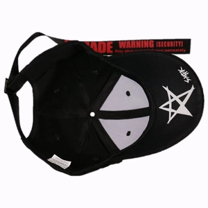 Detail of 100% cotton baseball cap showing white star print and warning tag long strap