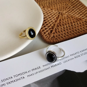 Detailed view of vintage adjustable S925 silver and gold rings with black onyx stones