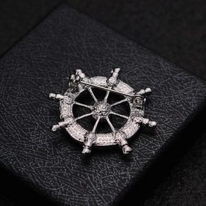 Silver nautical ship wheel lapel pin for men's suits shown from the back view