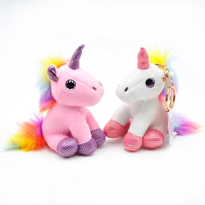 Detail of pink and white plush unicorns with rainbow manes and shiny sequin accents