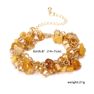 Detail of beaded bracelet with amber gravel stones and gold beads including size info