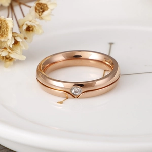 Minimalist rose gold titanium ring for couples with a single sparkling cubic zirconia stone