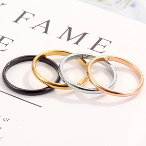 Polished titanium steel rings in black, gold, silver, and rose gold stacked for couples