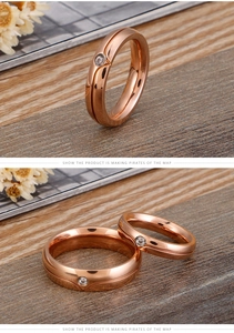 Macro detail of polished rose gold couple rings with inlaid sparkling zircons
