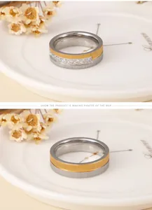 Close-up of matte titanium steel ring with two-tone gold finish and inlaid diamonds