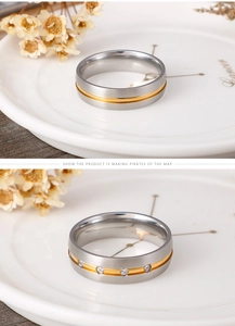 Detail of two-tone brushed titanium rings with subtle diamond accents for couples