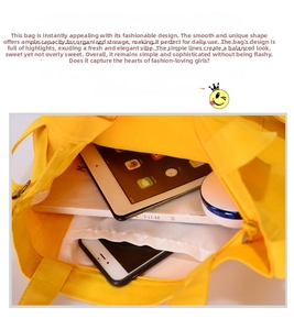 Detail view of large yellow canvas tote bag showing interior storage for tablets and books