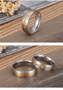 Detail of brushed matte steel ring with gold edges and small zircon stone inlays