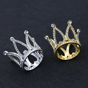 Macro shot of gold and silver crown cake toppers with sparkling crystal rhinestones