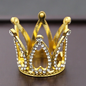 Macro view of gold birthday cake crown topper with sparkling clear rhinestones