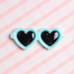 Detail of light blue heart-shaped mini sunglasses with black lenses for DIY plush dolls